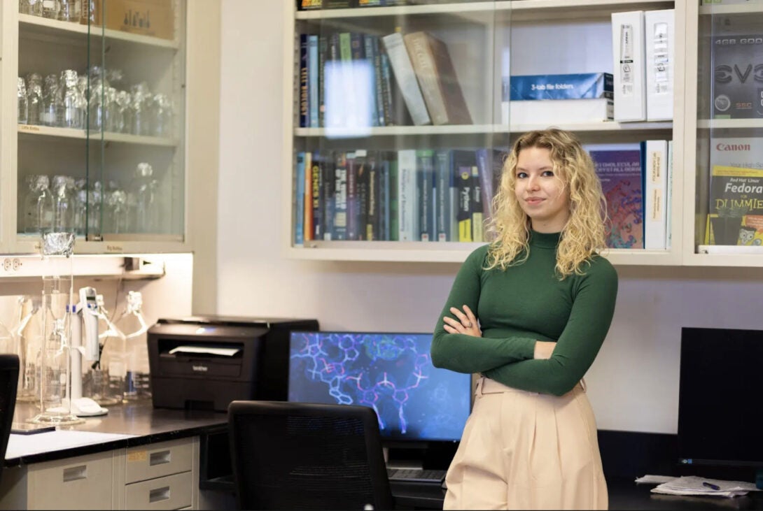 Picture of student in front of their lab